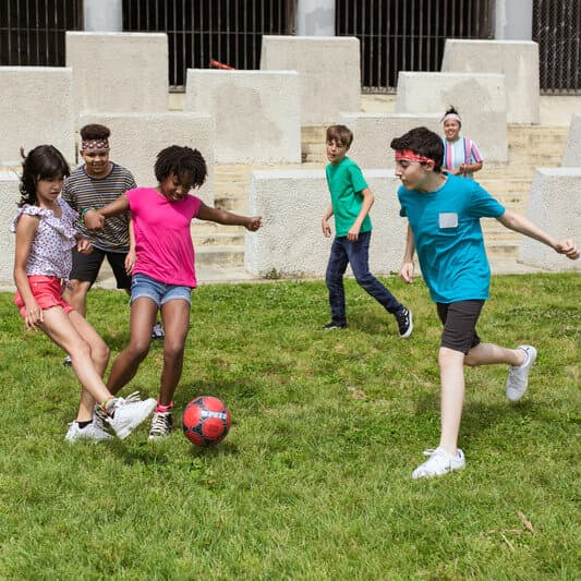Children playing a fun ball game together on the grass